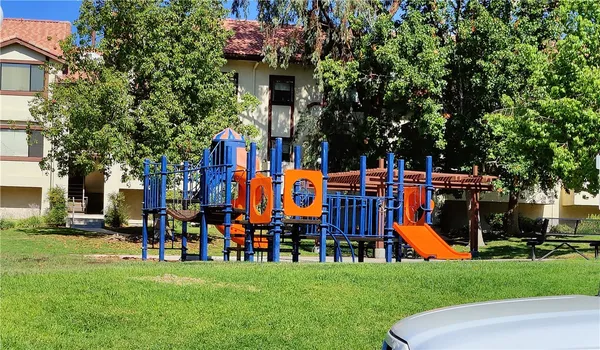 a childrens park with lots of swings and slides