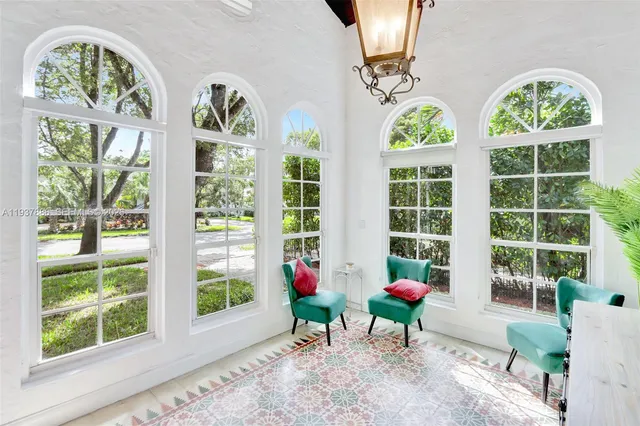 a living room filled with furniture and a large window