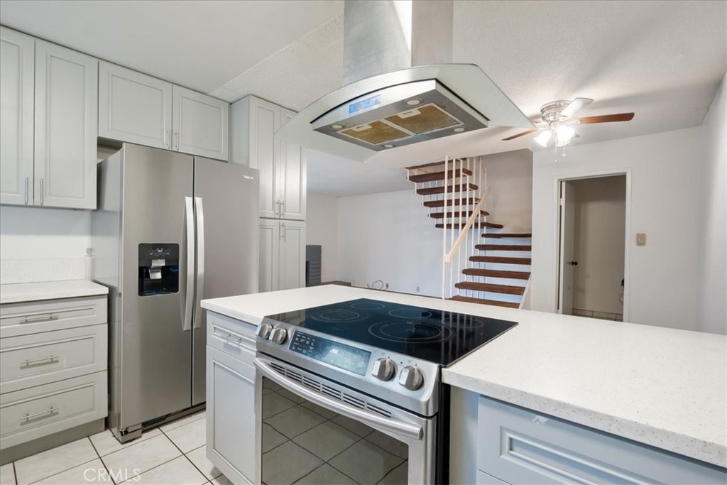 a kitchen with a stove cabinets and stainless steel appliances