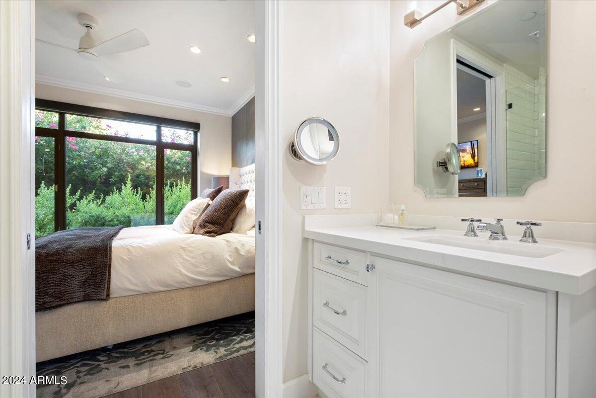 7175 East Camelback Road, Unit 107 Scottsdale, AZ 85251 - Photo 11 of 33 a en suite bathroom with a sink mirror and window