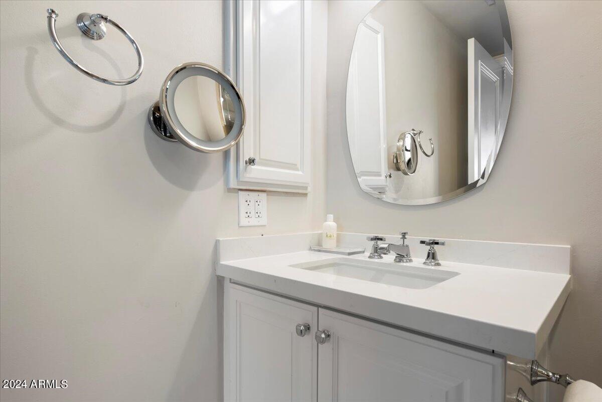 7175 East Camelback Road, Unit 107 Scottsdale, AZ 85251 - Photo 15 of 33 a bathroom with a sink and a mirror