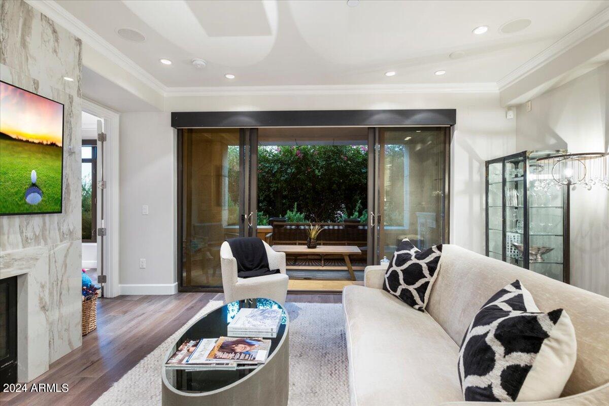 7175 East Camelback Road, Unit 107 Scottsdale, AZ 85251 - Photo 3 of 33 a living room with furniture and a floor to ceiling window