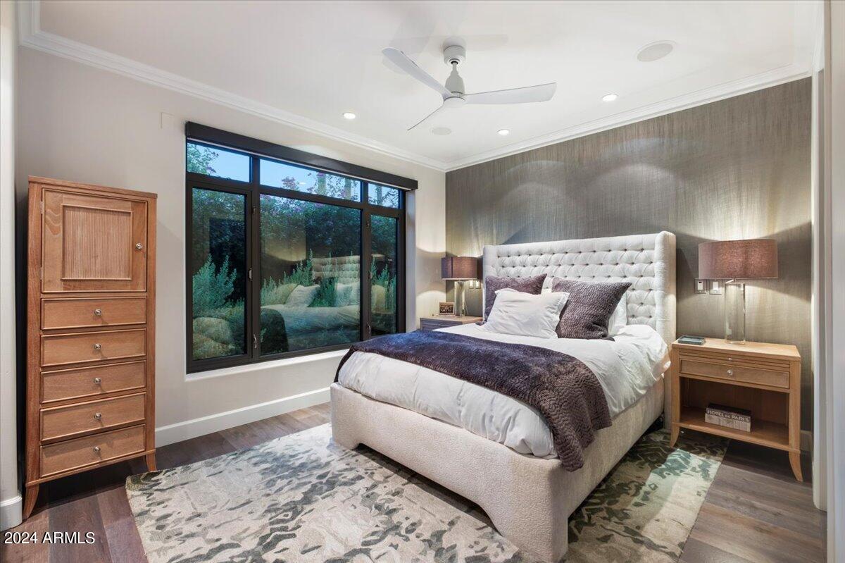 7175 East Camelback Road, Unit 107 Scottsdale, AZ 85251 - Photo 9 of 33 a large bedroom with a bed and wooden floor