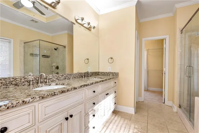 a bathroom with a granite countertop sink a toilet and bathtub