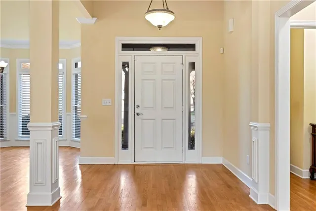 a view of a room with wooden floor closet and windows