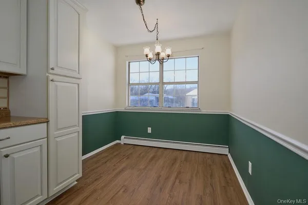 a view of room with window and wooden floor