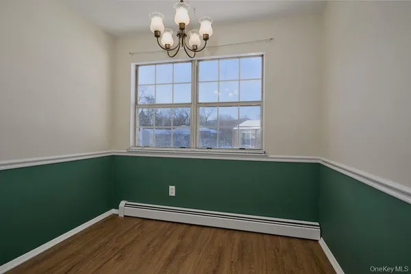 a view of a room with wooden floor and windows