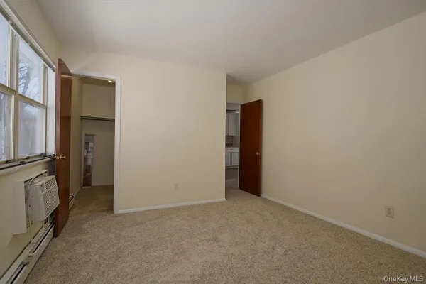 a view of an empty room with a fireplace