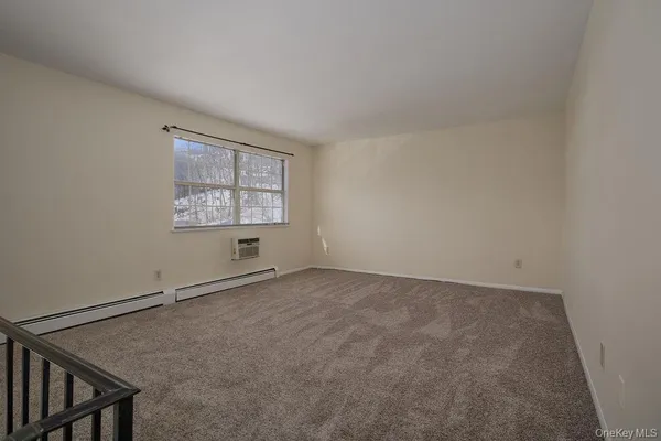 a view of an empty room and a window