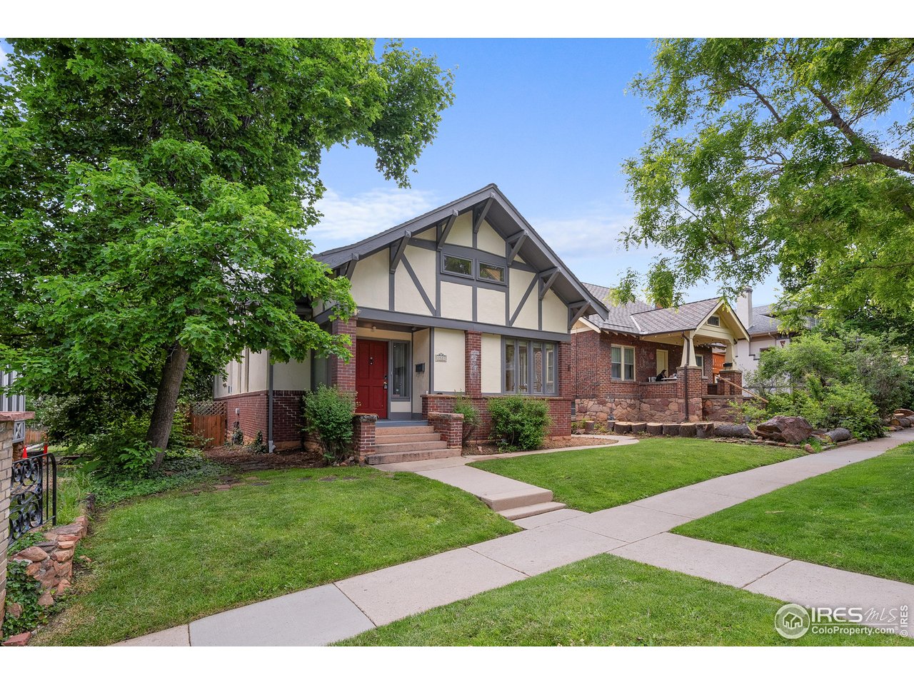 1020 10th Street Boulder, CO 80302 - Photo 1 of 38 a front view of a house with a garden and trees