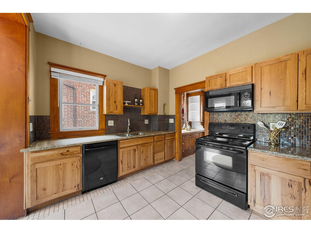 1020 10th Street Boulder, CO 80302 - Photo 17 of 38 a kitchen with stainless steel appliances granite countertop a stove a sink and a microwave