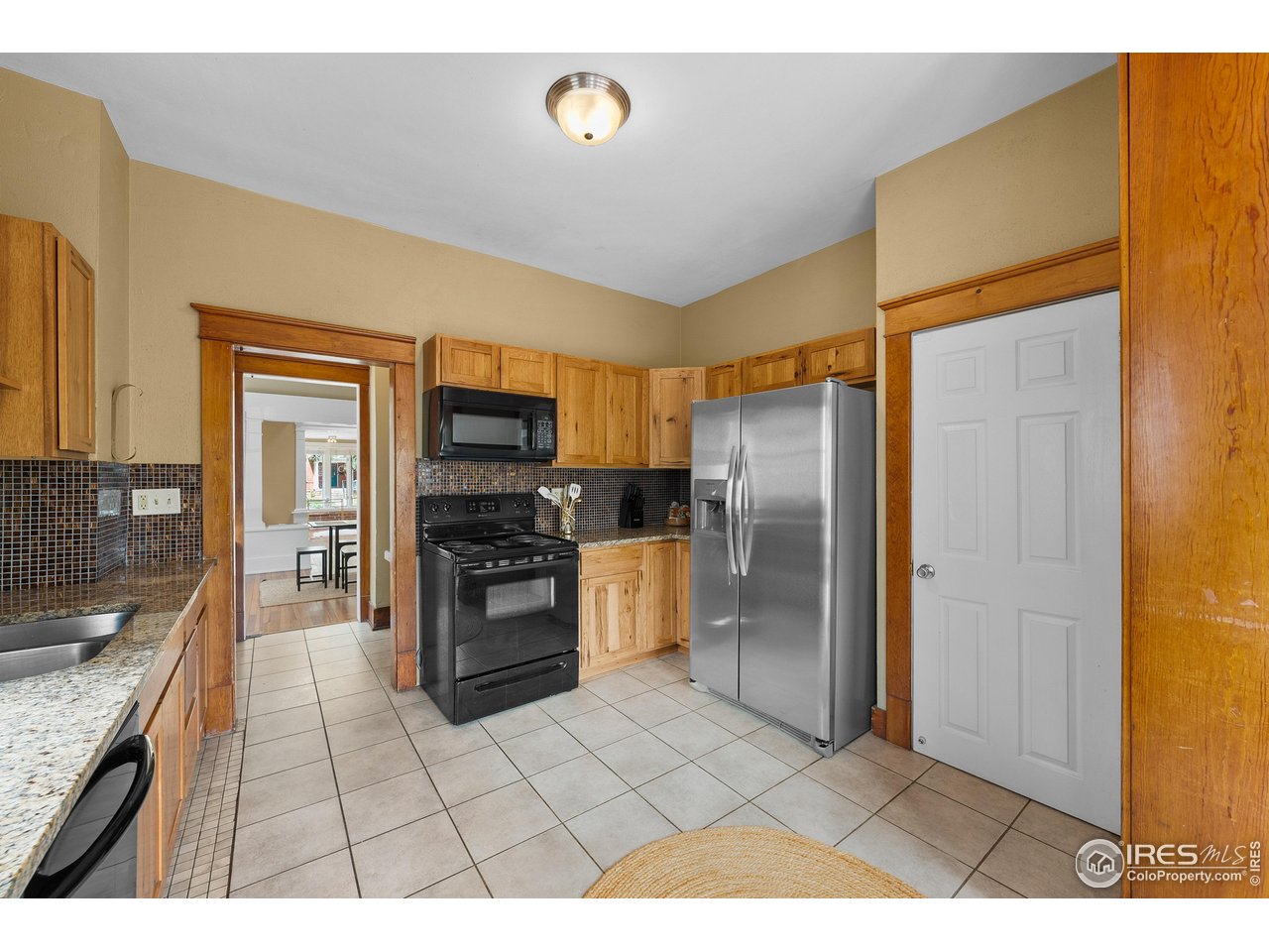 1020 10th Street Boulder, CO 80302 - Photo 18 of 38 a kitchen with stainless steel appliances granite countertop a refrigerator and a stove