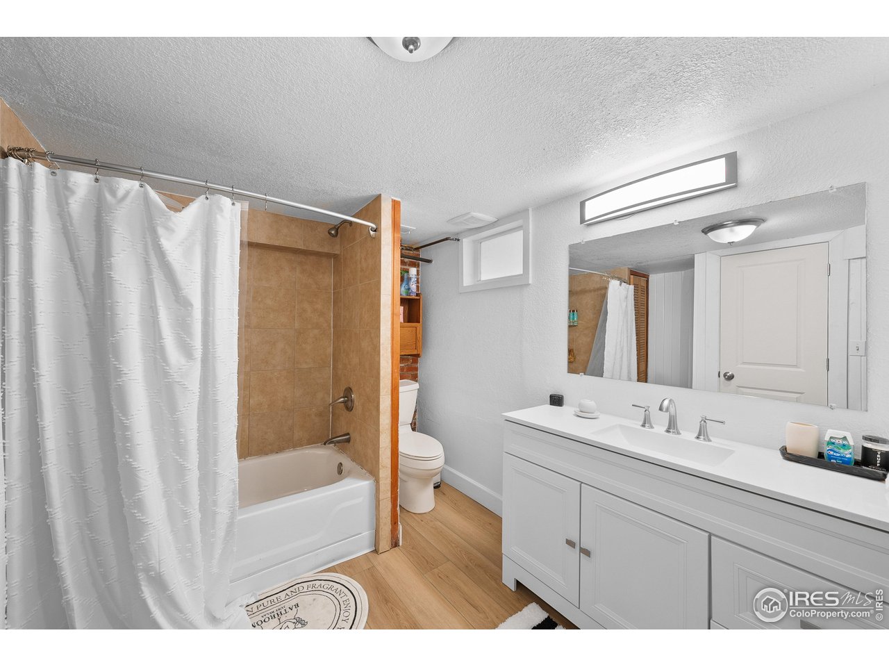 1020 10th Street Boulder, CO 80302 - Photo 30 of 38 a bathroom with a sink a mirror and a shower