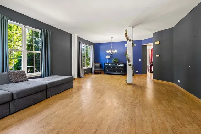 a view of a livingroom with furniture and a large window