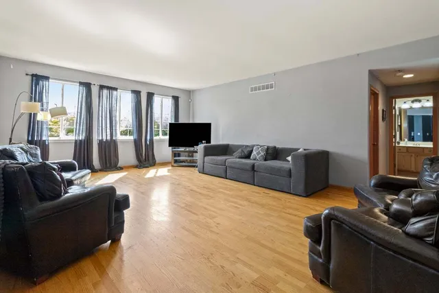 a living room with furniture window and a flat screen tv