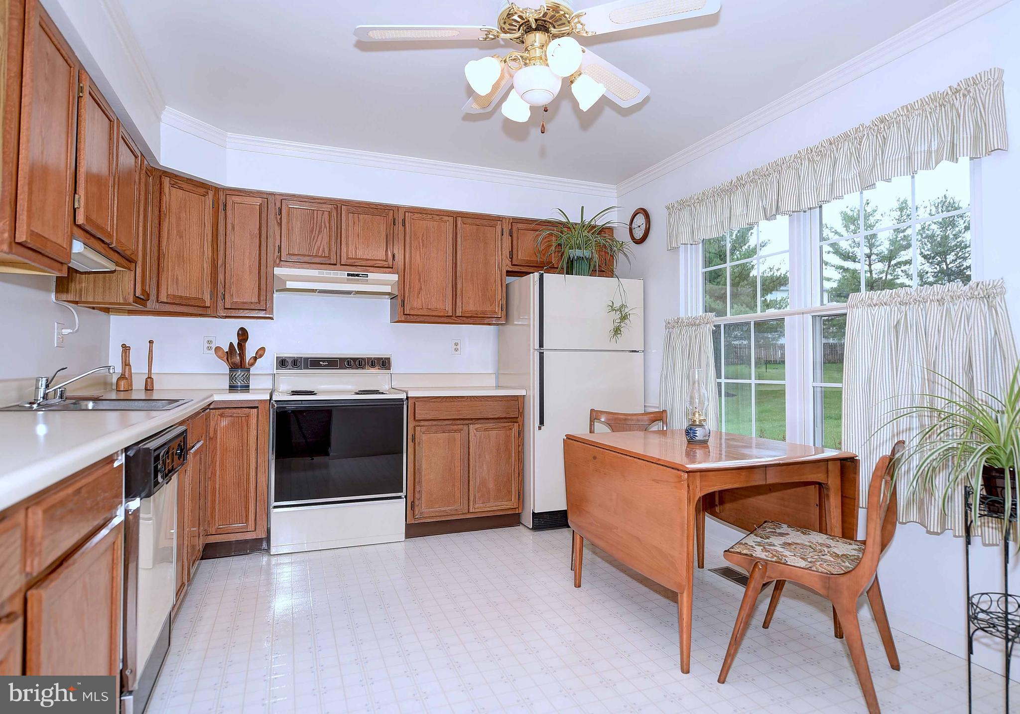 23 Offspring Court Perry Hall, MD 21128 - Photo 2 of 23 a kitchen with a dining table chairs and refrigerator
