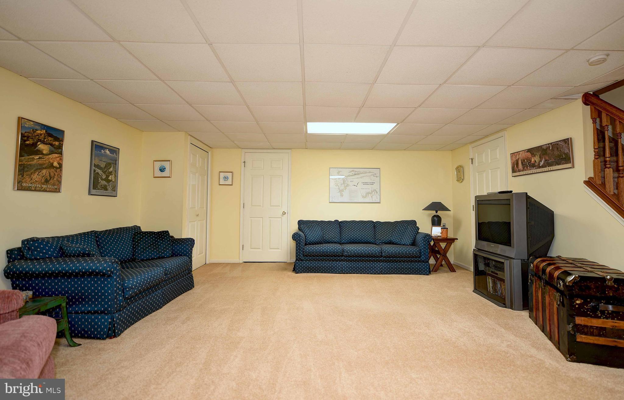 23 Offspring Court Perry Hall, MD 21128 - Photo 6 of 23 a living room with furniture a flat screen tv and gym equipment