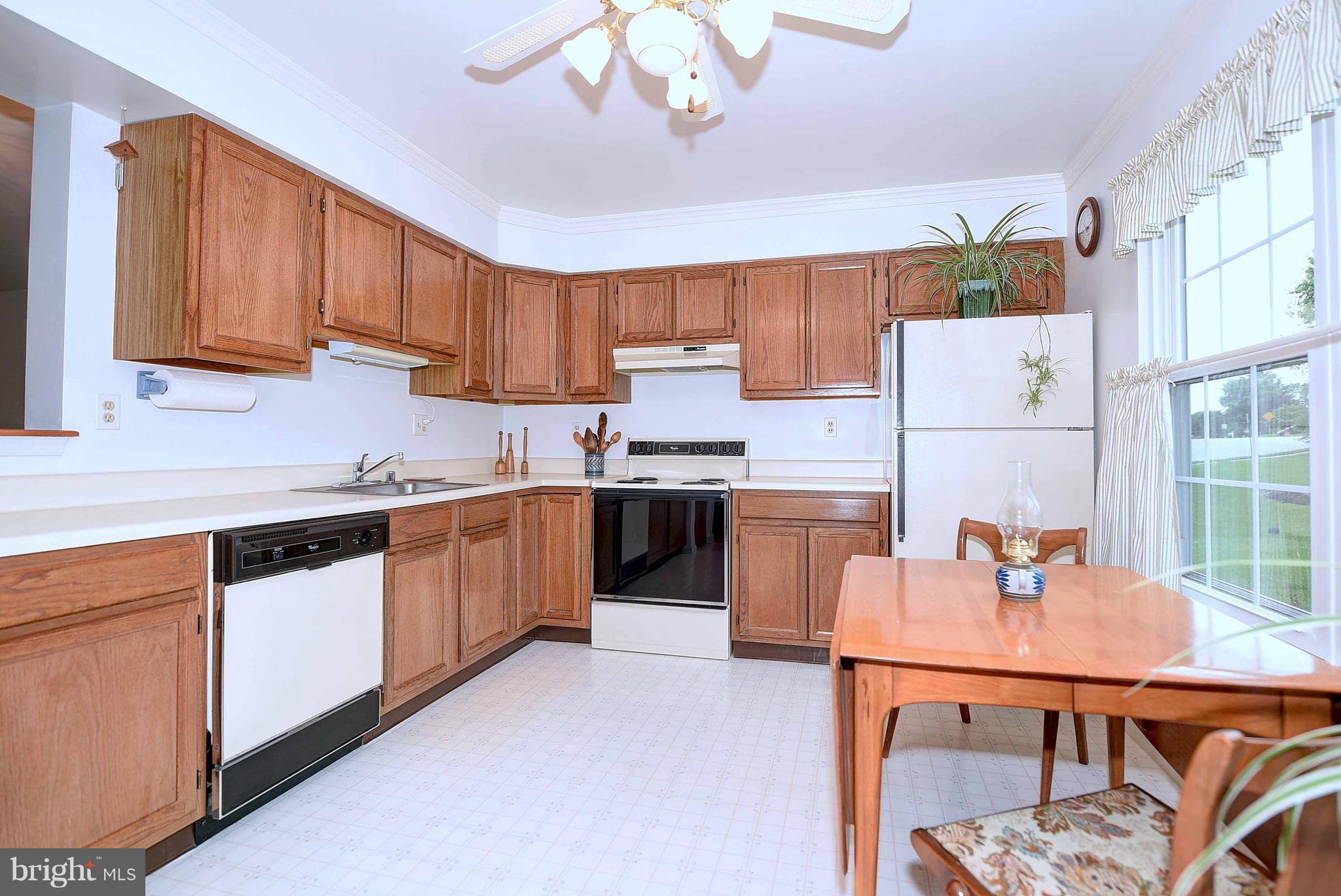 23 Offspring Court Perry Hall, MD 21128 - Photo 8 of 23 a kitchen with stainless steel appliances granite countertop a sink dishwasher and a refrigerator with wooden cabinets