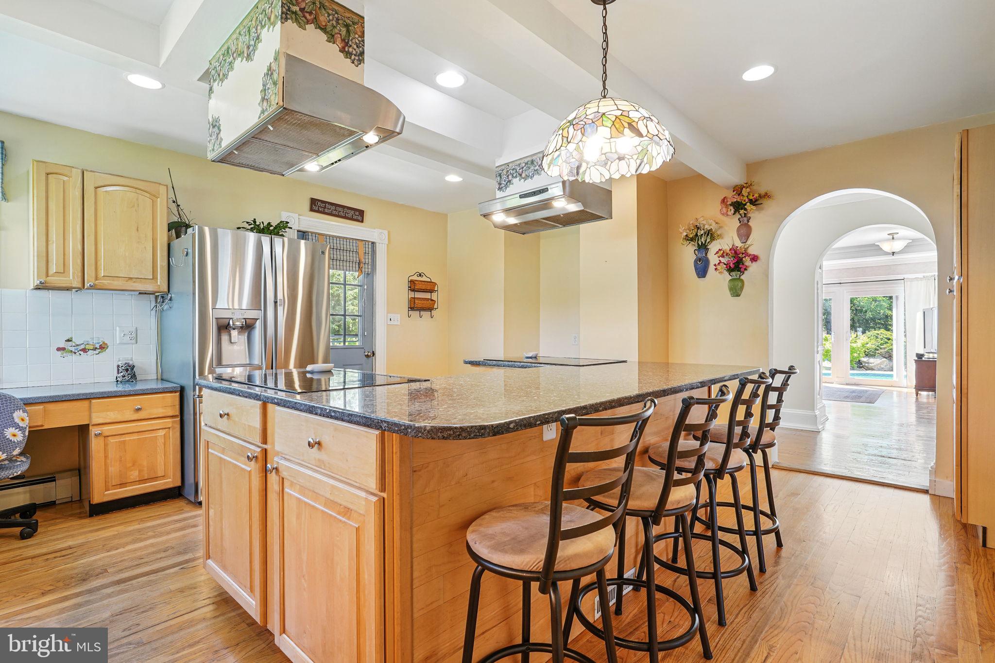 5365 Buena Vista Road Prince Frederick, MD 20678 - Photo 54 of 74 a kitchen with stainless steel appliances granite countertop a kitchen island a stove and a wooden floors