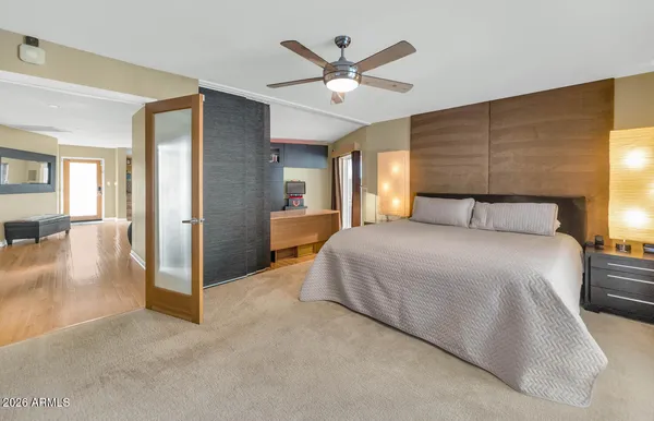 a bedroom with a bed and a large window