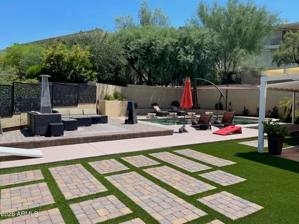 a living room with patio furniture tv and a fountain