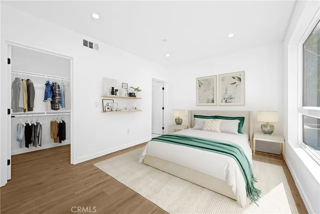 a bedroom with a bed and a view of kitchen