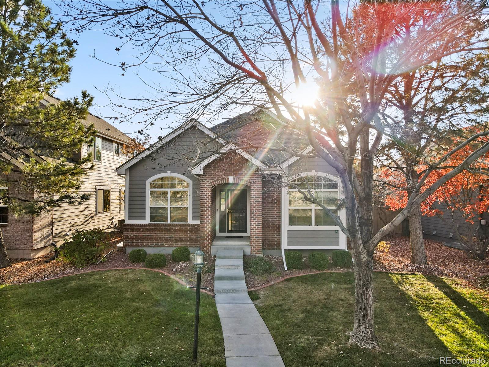 6900 West Grant Ranch Boulevard, Unit 53 Littleton, CO 80123 - Photo 2 of 31 a front view of a house with garden