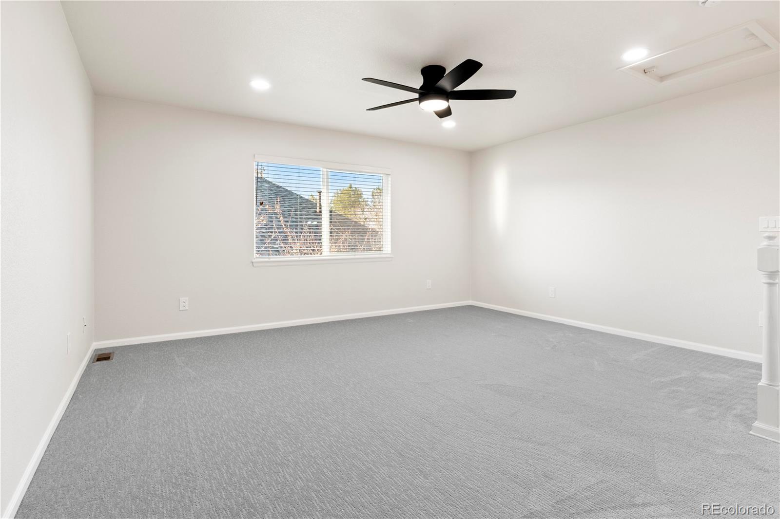 6900 West Grant Ranch Boulevard, Unit 53 Littleton, CO 80123 - Photo 24 of 31 an empty room with a window and a ceiling fan