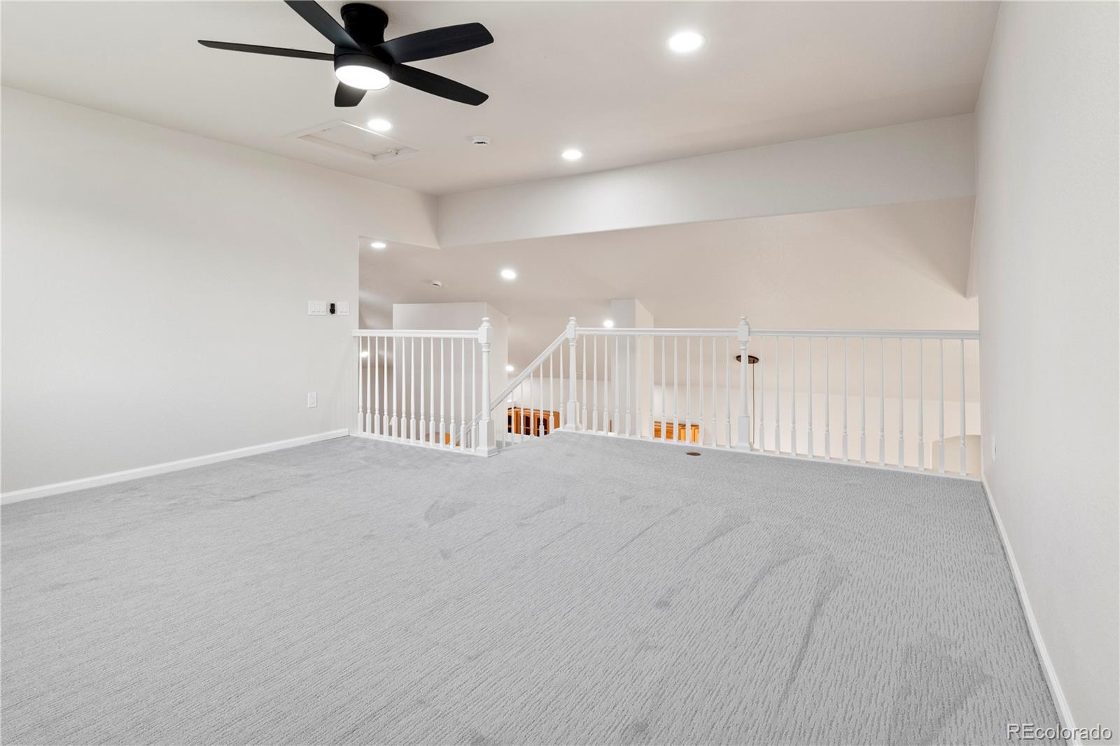 6900 West Grant Ranch Boulevard, Unit 53 Littleton, CO 80123 - Photo 25 of 31 an empty room with a ceiling fan and window