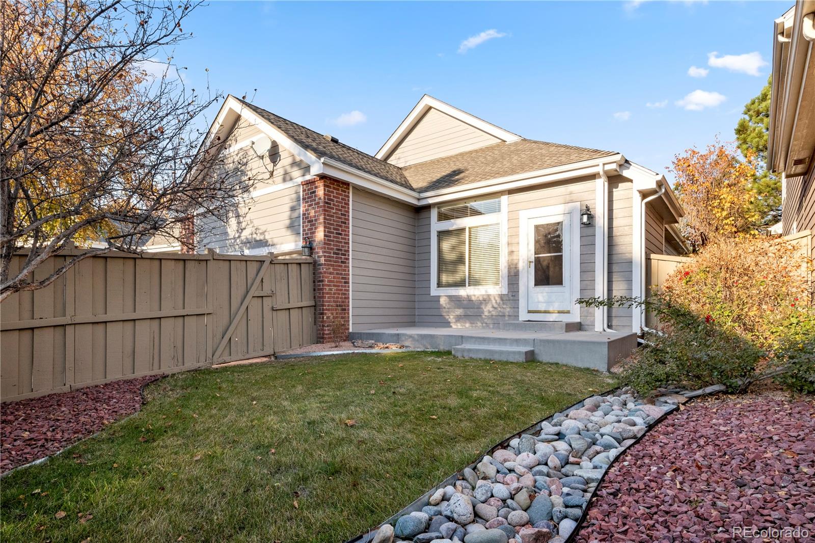 6900 West Grant Ranch Boulevard, Unit 53 Littleton, CO 80123 - Photo 27 of 31 a view of a front of a house with a yard