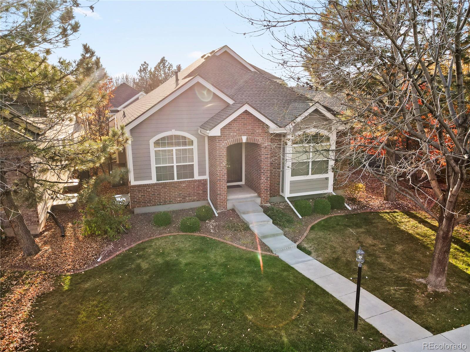 6900 West Grant Ranch Boulevard, Unit 53 Littleton, CO 80123 - Photo 3 of 31 a front view of a house with garden
