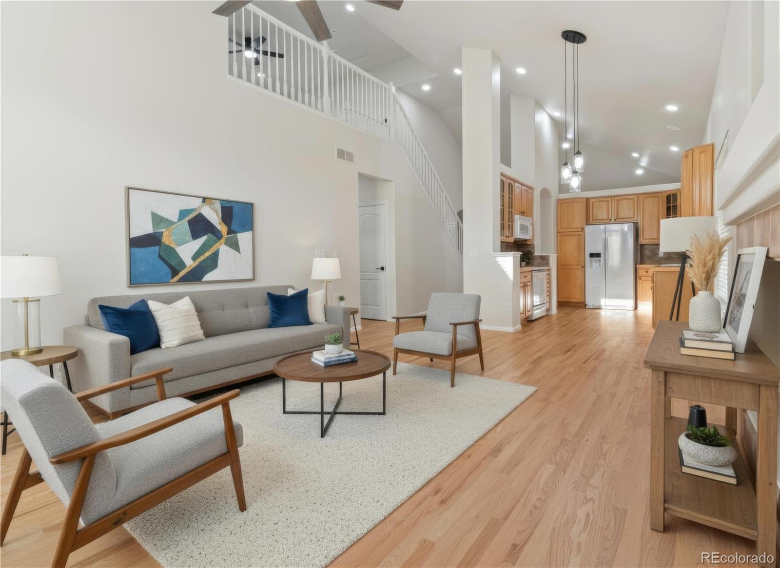 6900 West Grant Ranch Boulevard, Unit 53 Littleton, CO 80123 - Photo 6 of 31 a living room with furniture and a wooden floor