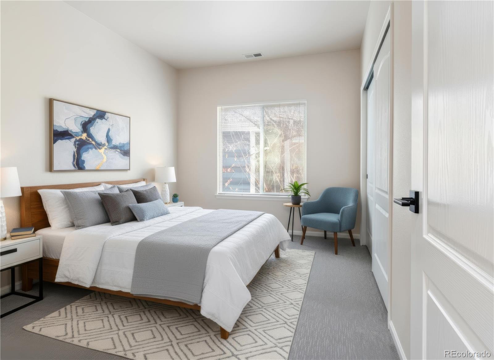 6900 West Grant Ranch Boulevard, Unit 53 Littleton, CO 80123 - Photo 8 of 31 a bedroom with a bed and a large window