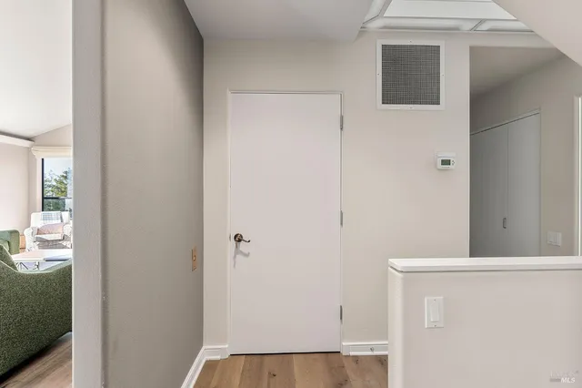 a large bed sitting in a bedroom next to a window