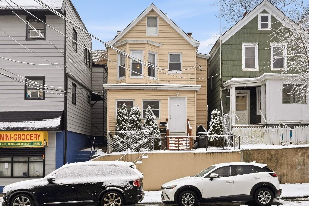 a front view of a house with parking space