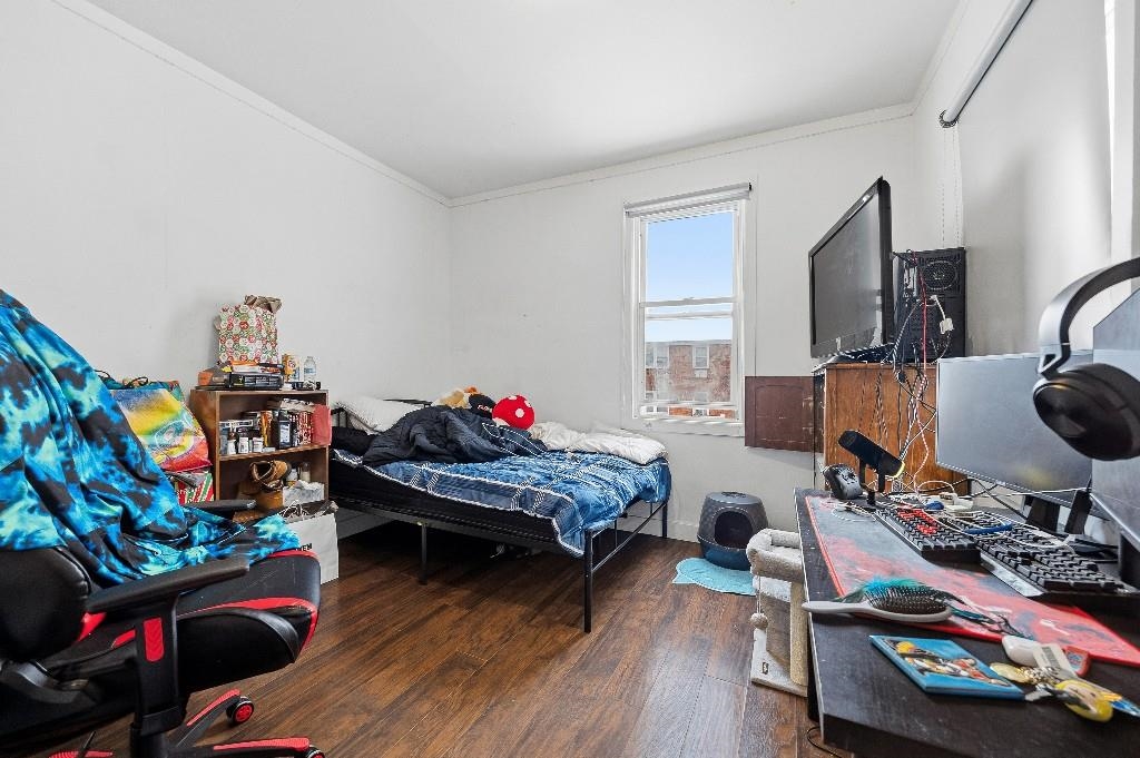 383 Broadway Passaic, NJ 07055 - Photo 5 of 21 a bed room with furniture and a wooden floor