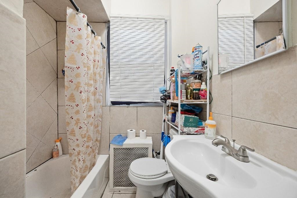383 Broadway Passaic, NJ 07055 - Photo 8 of 21 a bathroom with a sink toilet and shower