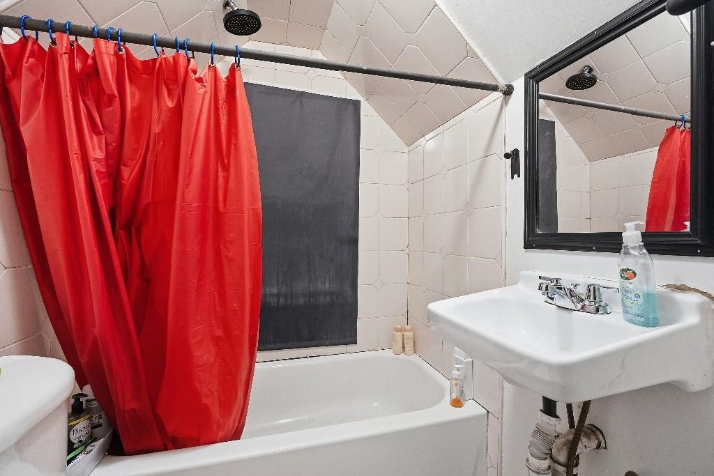 383 Broadway Passaic, NJ 07055 - Photo 10 of 21 a bathroom with a sink and a mirror