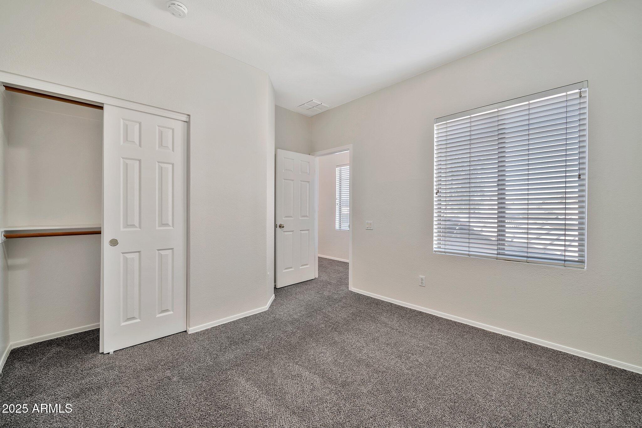 9437 West Berkeley Road Phoenix, AZ 85037 - Photo 13 of 21 a view of an empty room with a window