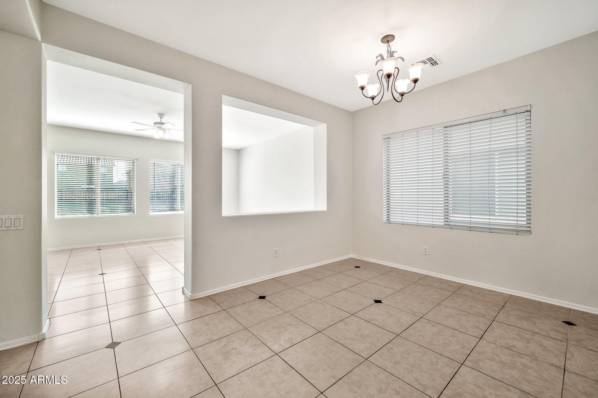 9437 West Berkeley Road Phoenix, AZ 85037 - Photo 5 of 21 a view of an empty room with a window