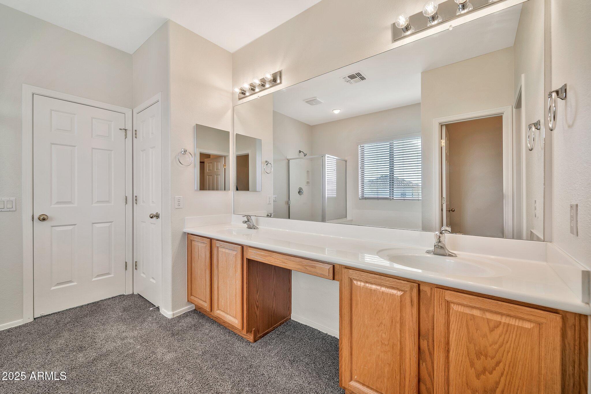 9437 West Berkeley Road Phoenix, AZ 85037 - Photo 8 of 21 a bathroom with a granite countertop double vanity sink and mirror
