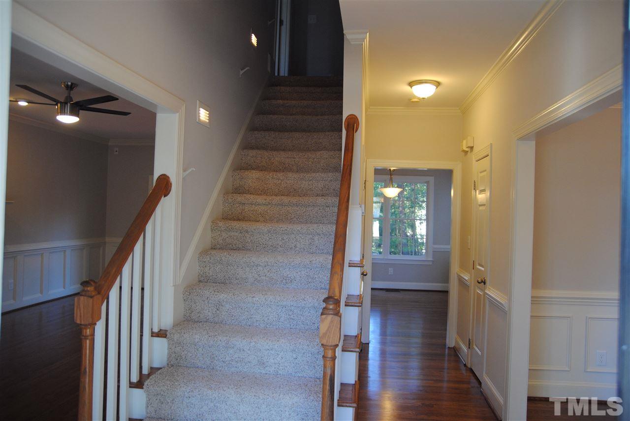 2004 Vintners Court Raleigh, NC 27610 - Photo 2 of 16 a view of a hallway with wooden floor and staircase