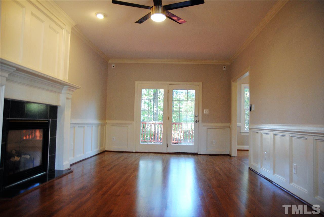 2004 Vintners Court Raleigh, NC 27610 - Photo 3 of 16 an empty room with wooden floor fireplace and windows
