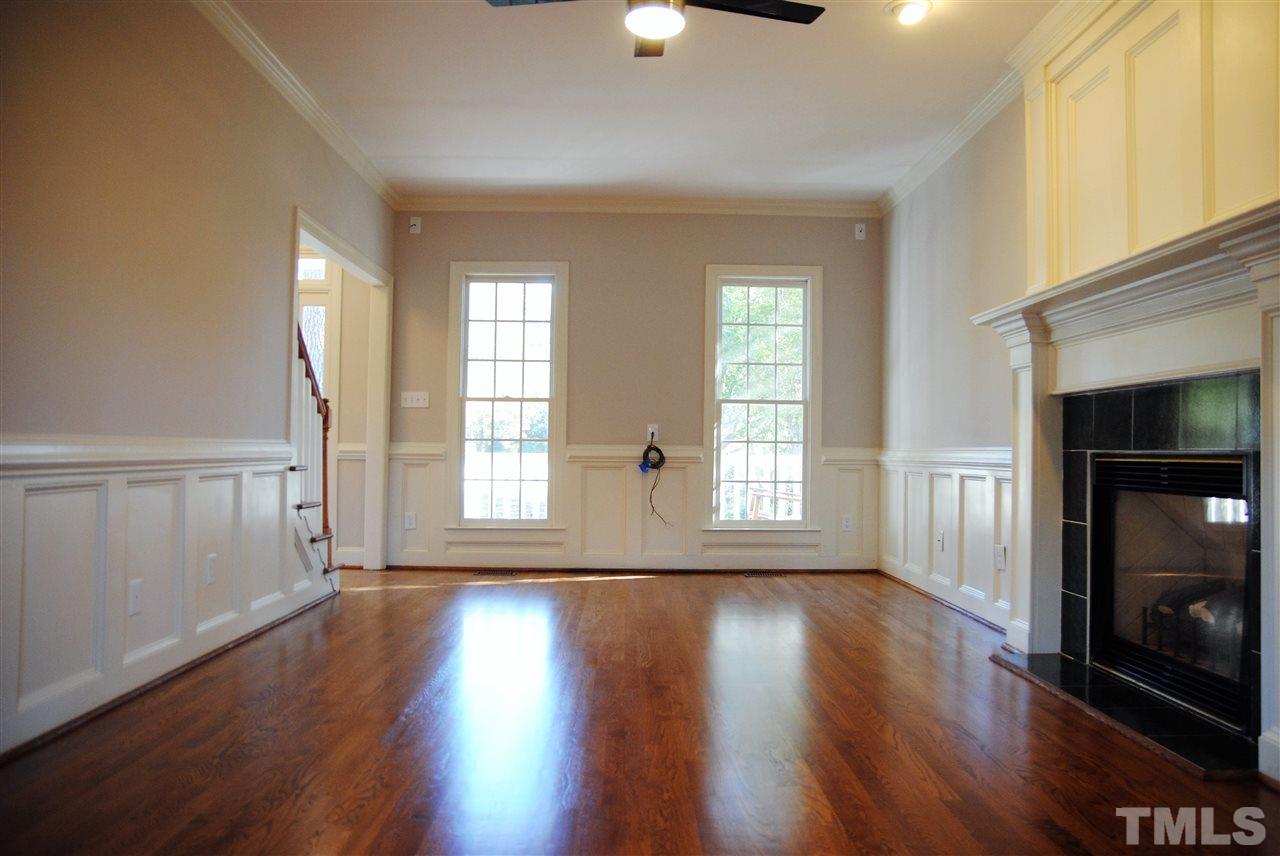 2004 Vintners Court Raleigh, NC 27610 - Photo 4 of 16 a view of an empty room with wooden floor fireplace and a window