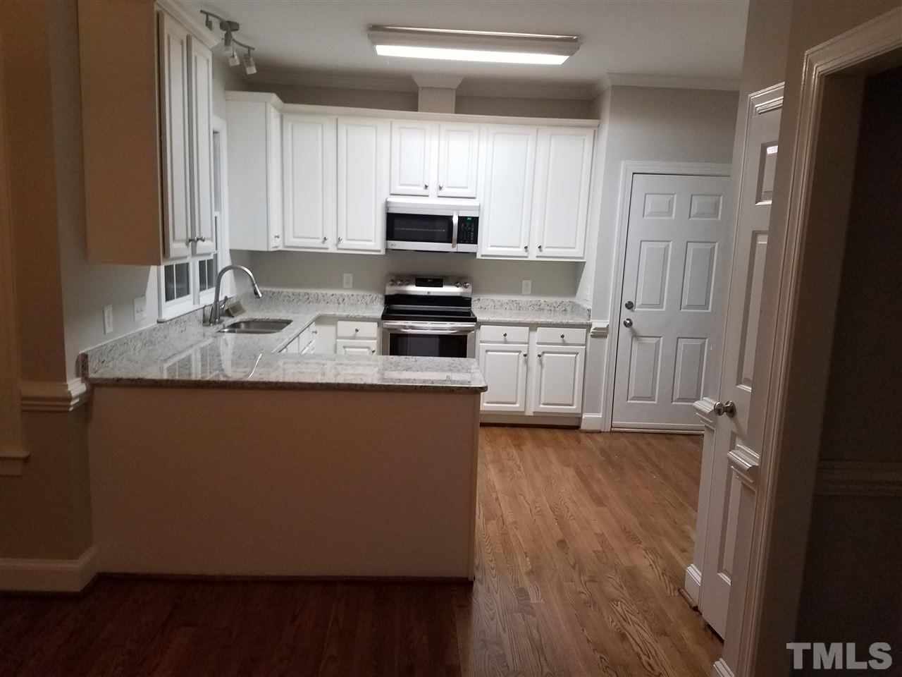 2004 Vintners Court Raleigh, NC 27610 - Photo 5 of 16 a kitchen with stainless steel appliances granite countertop a stove a sink and a refrigerator