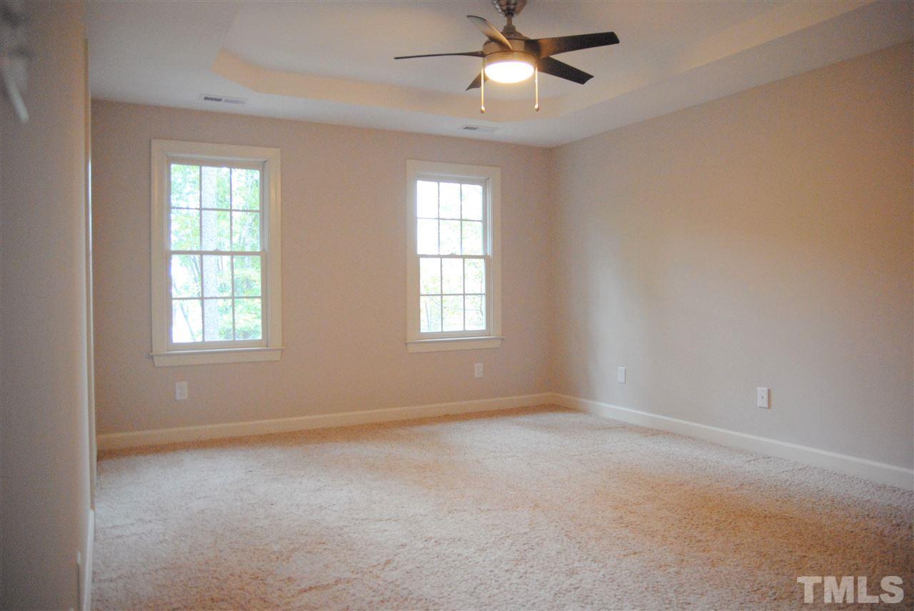 2004 Vintners Court Raleigh, NC 27610 - Photo 9 of 16 an empty room with windows and fan