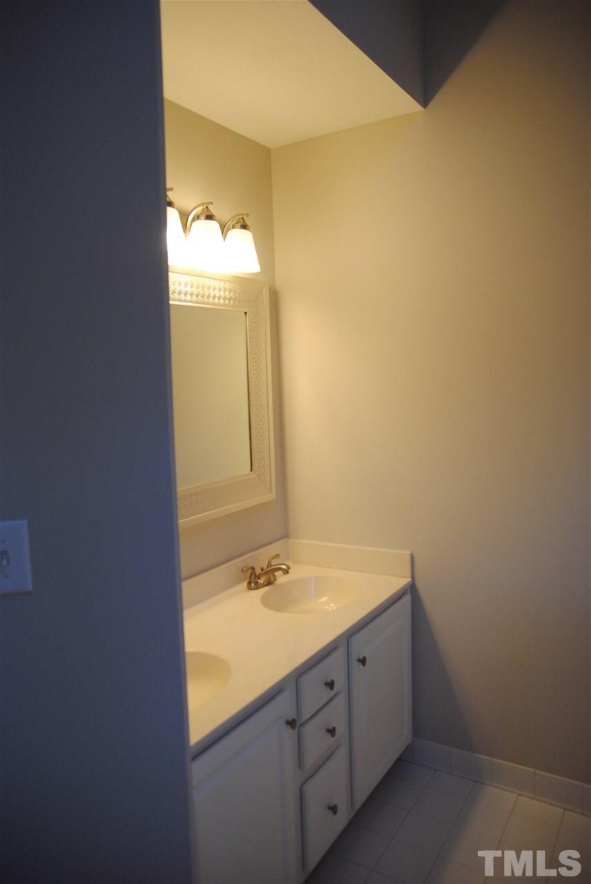 2004 Vintners Court Raleigh, NC 27610 - Photo 10 of 16 a bathroom with a sink and a mirror