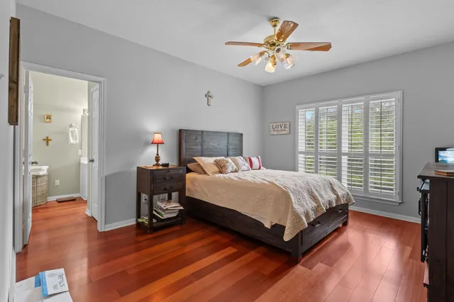 a spacious bedroom with a bed and a chandelier
