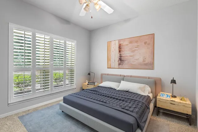 a bedroom with a large bed and a window