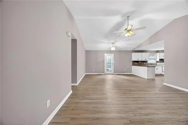 a view of a kitchen with a dishwasher and wooden floor